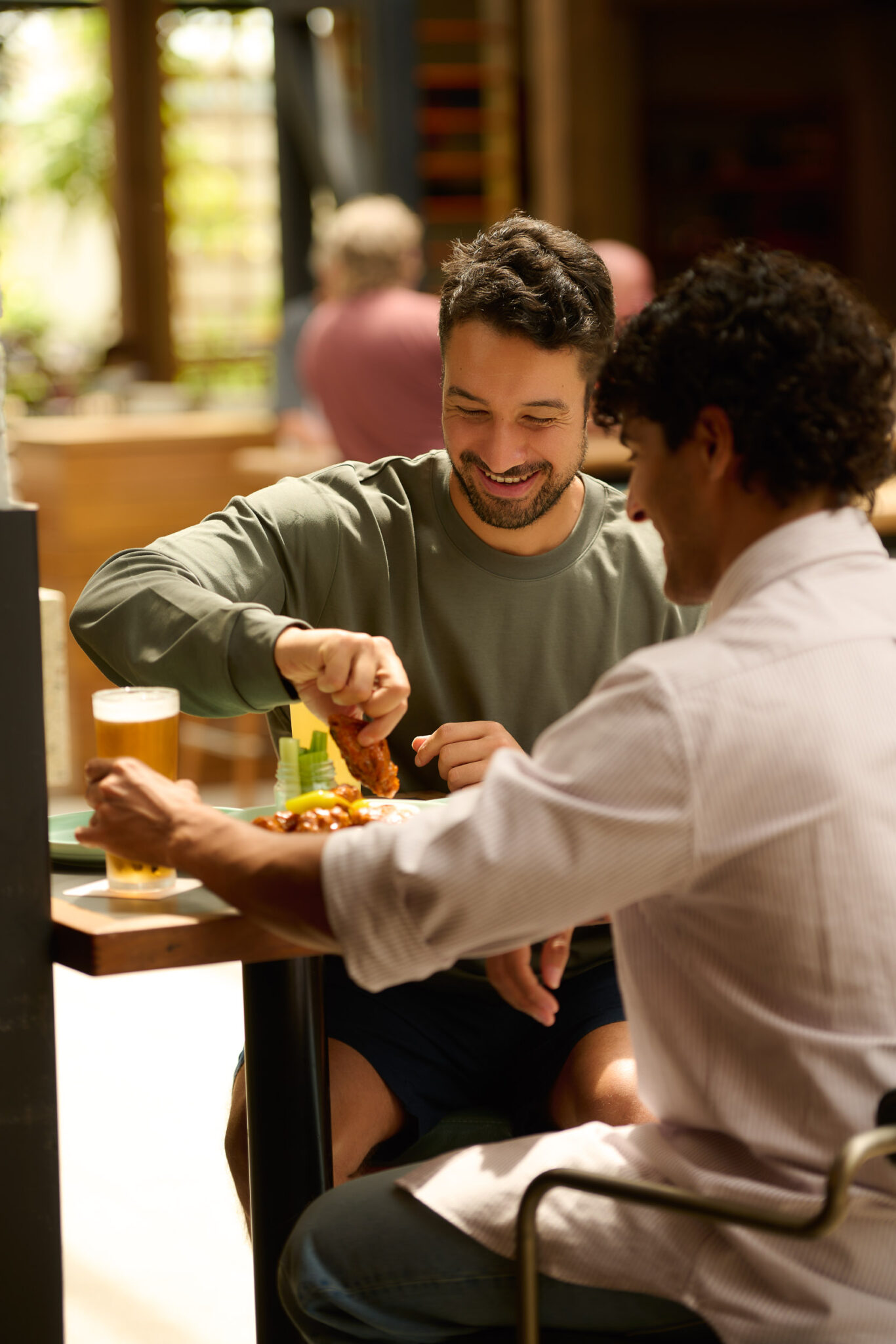 Guys drinking beer at Battery house bar at DYRSL