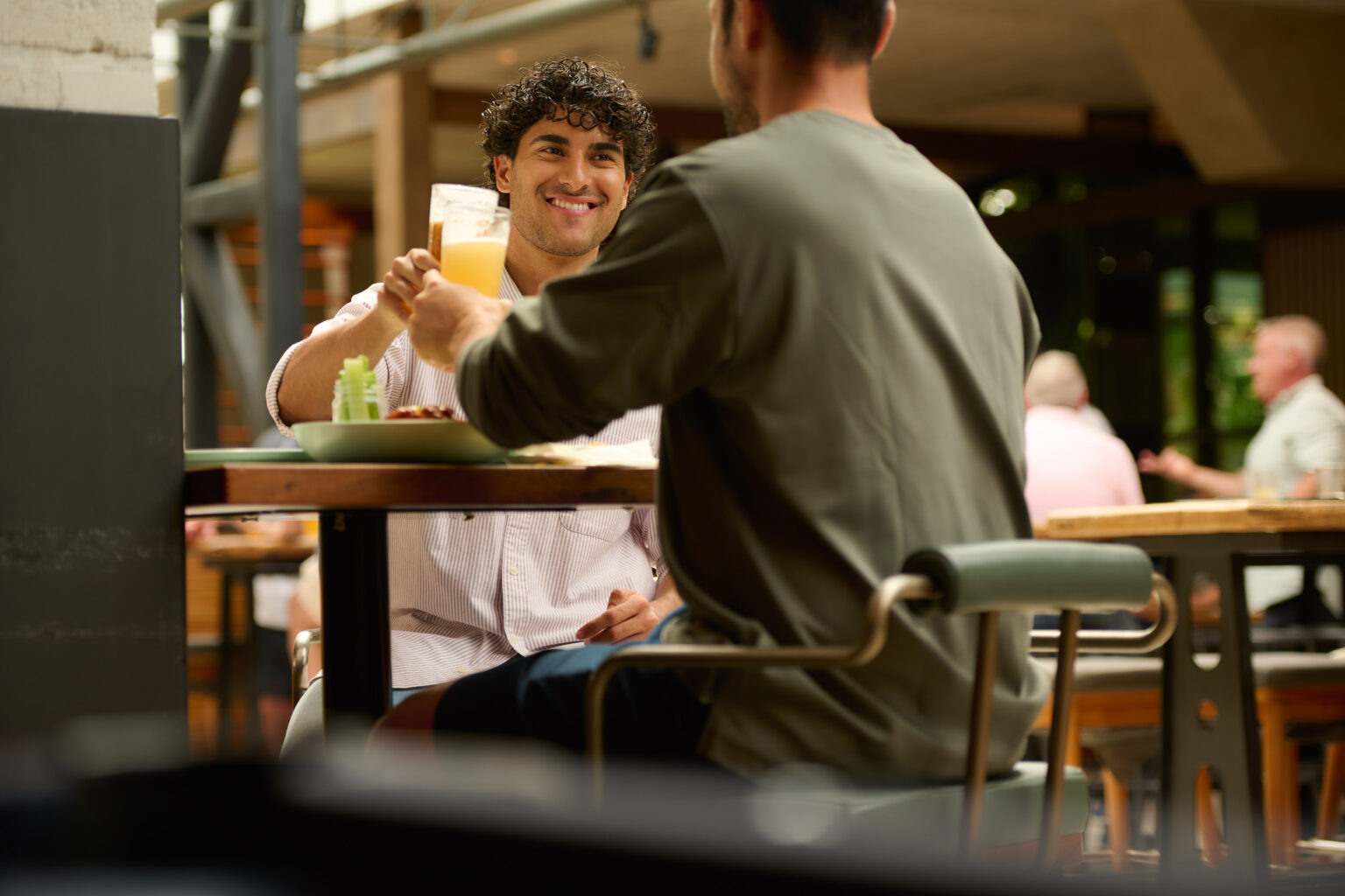 Guys drinking beer at Battery house bar at DYRSL