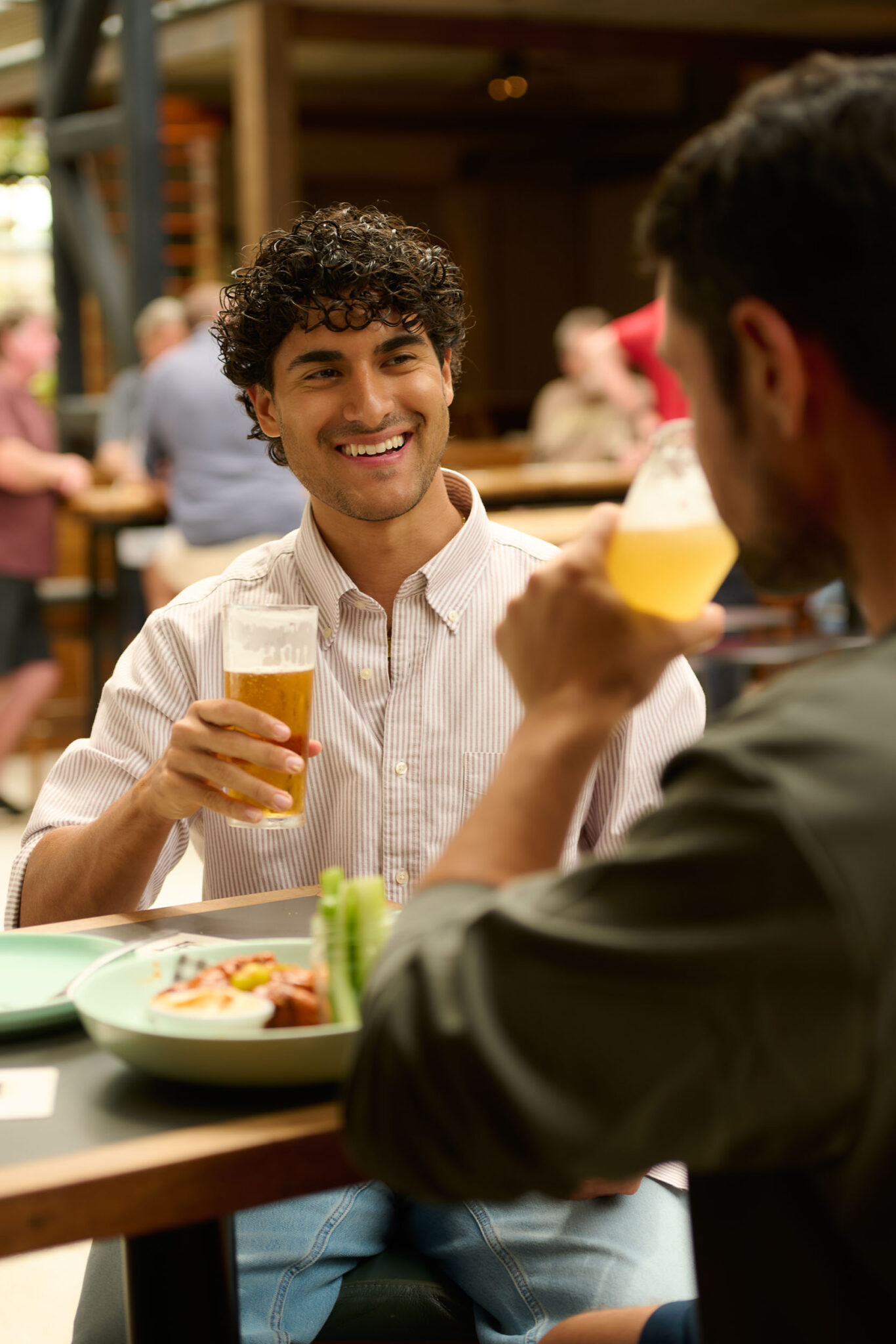 Guys drinking beer at Battery house bar at DYRSL